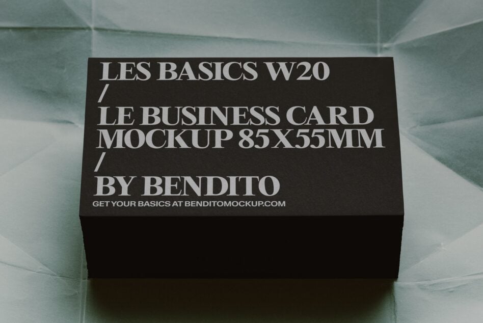 Black business card mockup 85x55mm sitting on translucent mint surface with shadow
