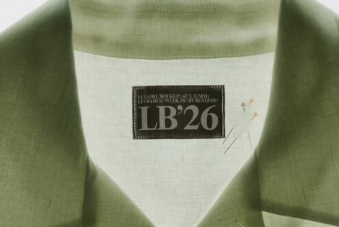 Sage green sweatshirt with cream label mockup showing LB'26 branding on fabric