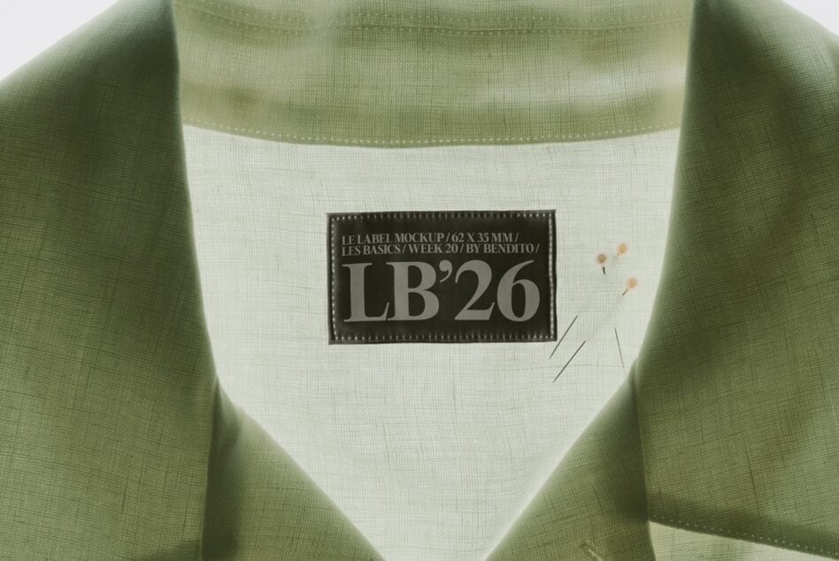 Sage green sweatshirt with cream label mockup showing LB'26 branding on fabric
