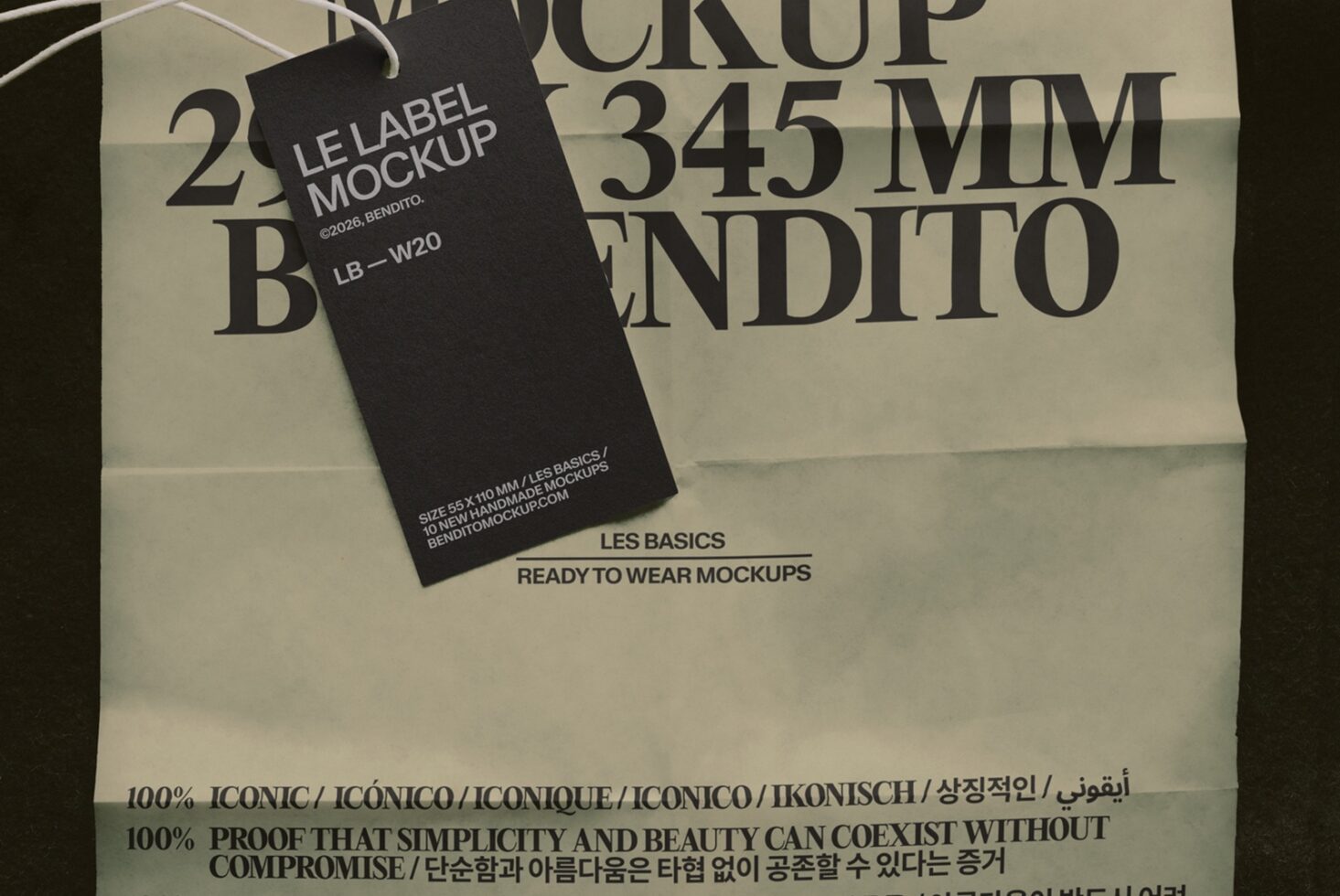 Black clothing label mockup draped on cream fabric with bold typography in background