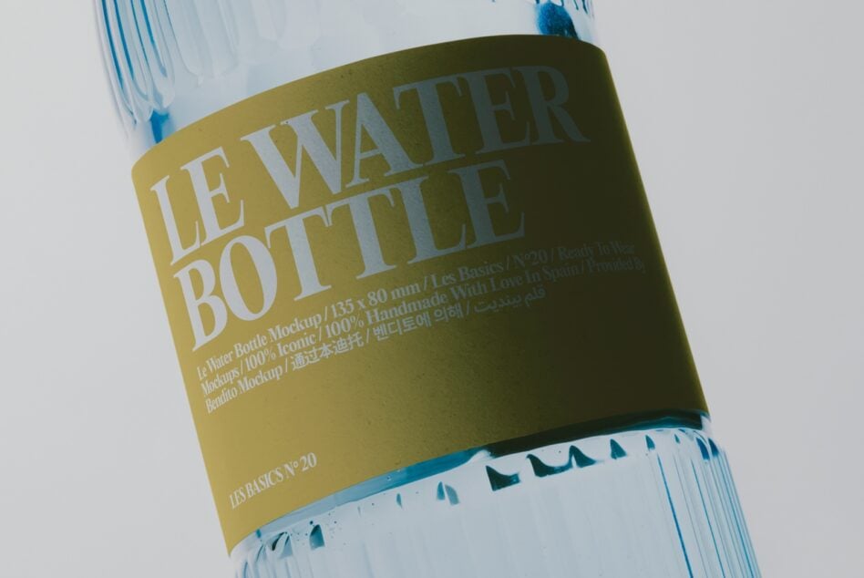 Water bottle with olive label showing "Le Water Bottle" text in white serif font, blue cap, multilingual copy visible