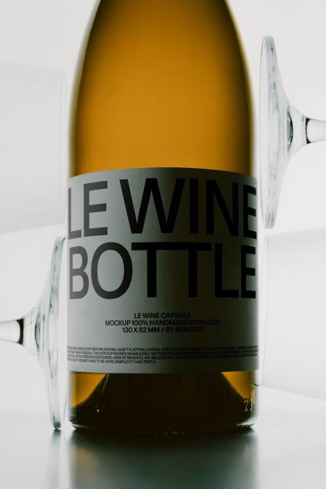 Wine bottle mockup with wraparound label showing bold typography on white background with glass