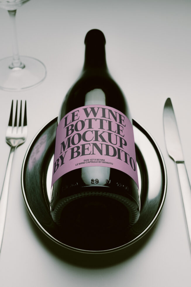 Wine bottle label mockup on place setting with fork, glass, knife