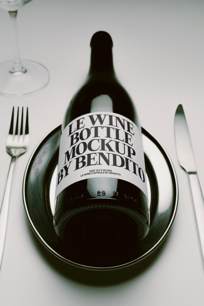 Wine bottle with label mockup on place setting with fork, glass, knife