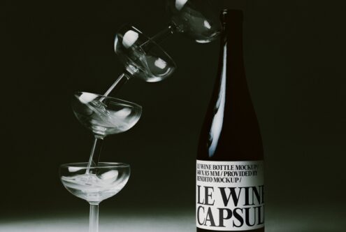 Wine bottle mockup with pouring glass on dark background, ice cubes catching light