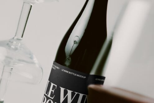 Wine bottle mockup with black label on white background, close-up shot showing glass details