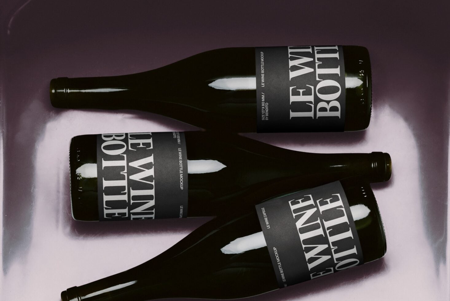 Three dark wine bottles with black labels arranged on a soft purple background with dramatic lighting
