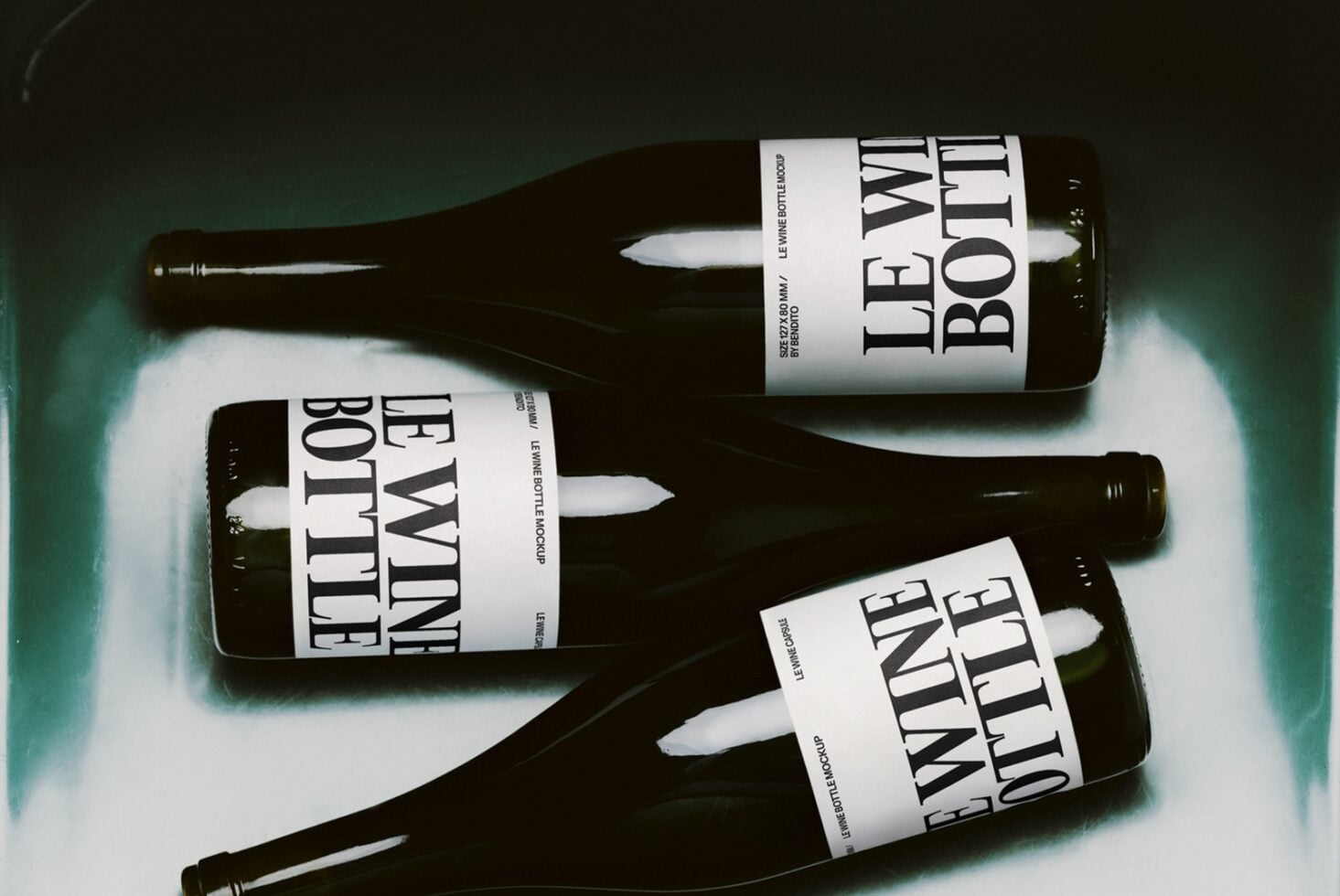 Dark wine bottles with bold serif labels on teal background, shot from above