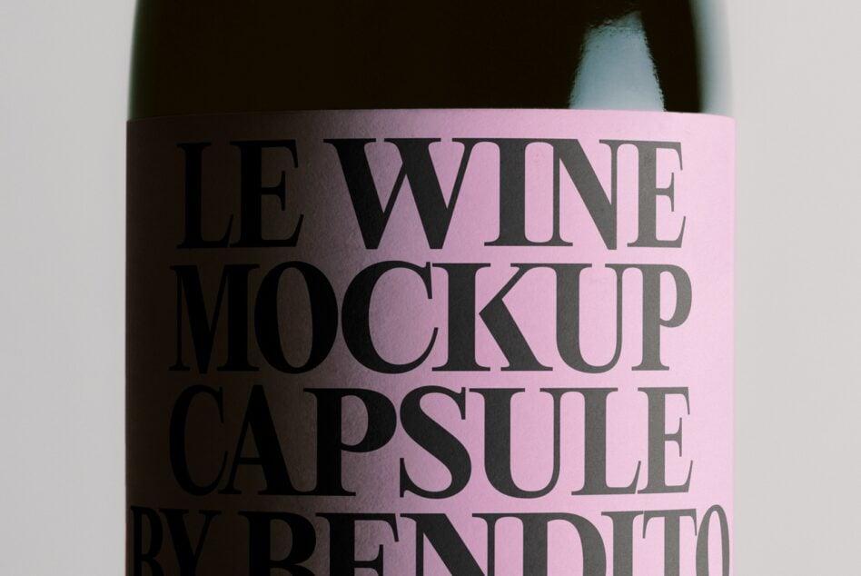 Wine bottle with pink gradient label showing bold serif typography in black text