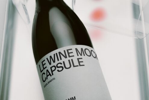 Wine bottle mockup with minimal label showing modern sans serif typography in soft focus setting