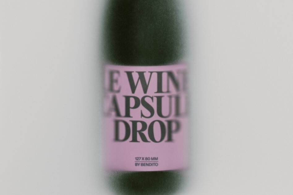 Blurred wine bottle with pink label showing "LEWIN APSULI DROP" text by Bendito