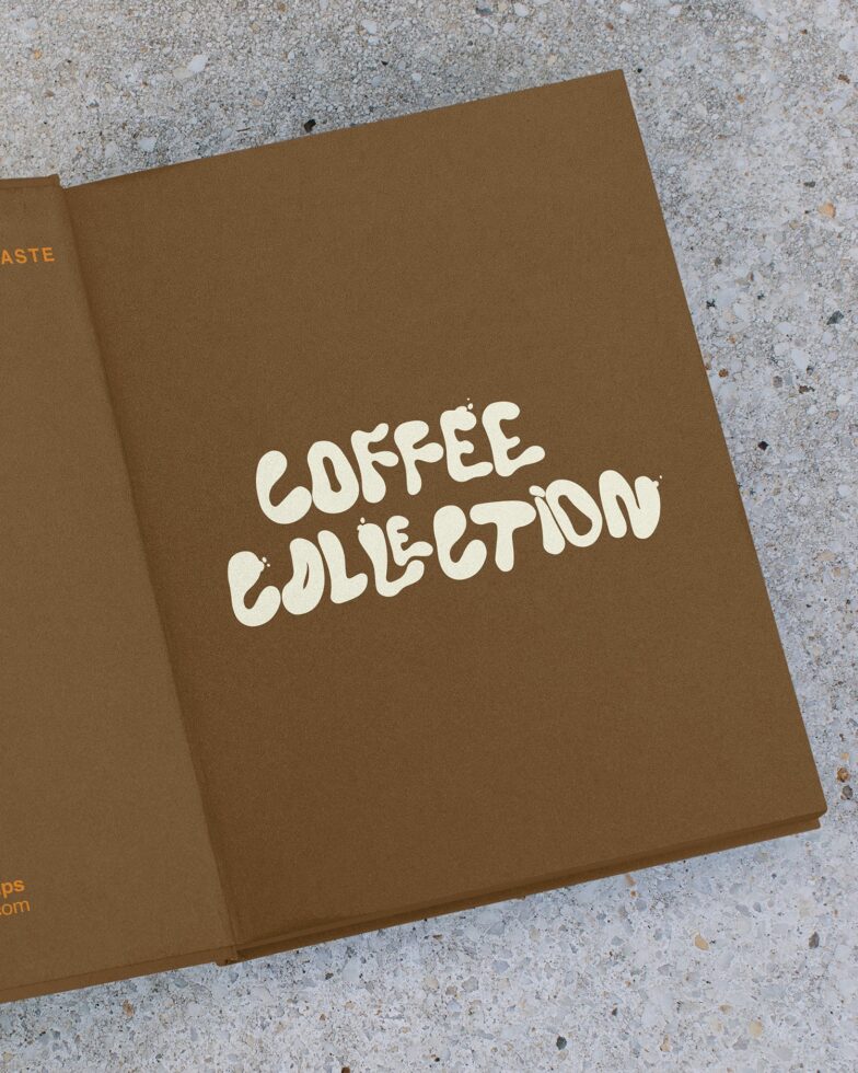 Open brown folder showing Coffee Collection lettering on right page against concrete background
