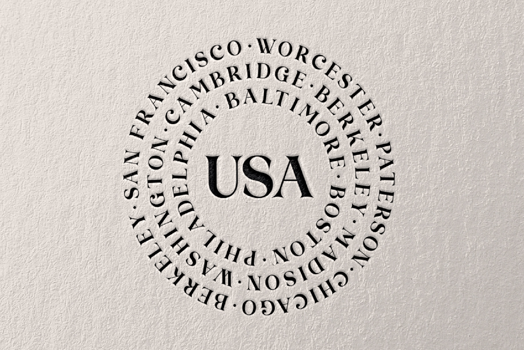 Circular text design with USA centered, surrounded by US city names in serif type