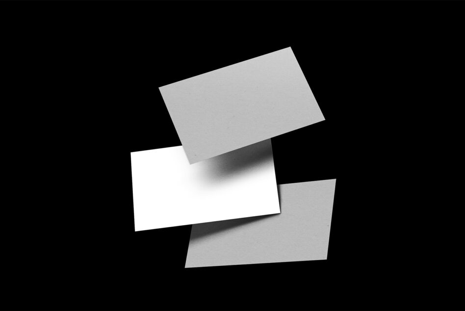 Stacked business cards mockup with realistic shadows on black background