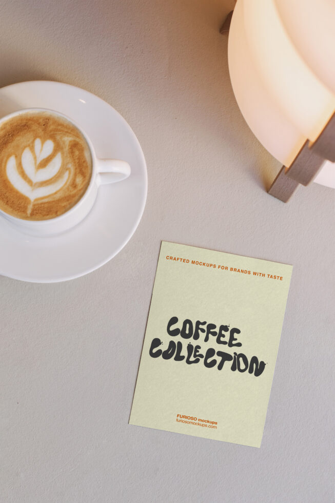 Overhead view of cappuccino cup, lit lamp, cream card with Coffee Collection