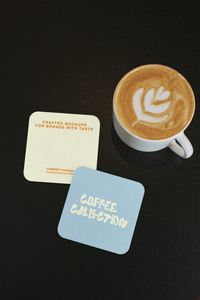 Cream, light blue coasters with espresso cup latte art on dark surface
