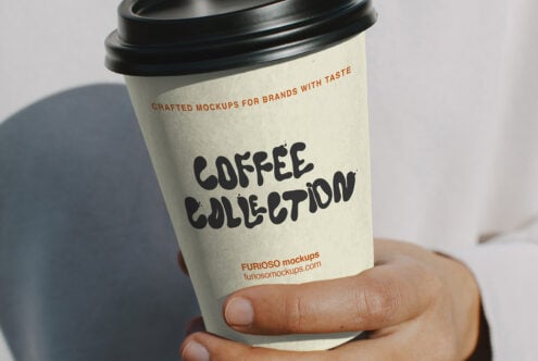 Cream to-go cup with black lid held in hand, Coffee Collection text in dark chunky font