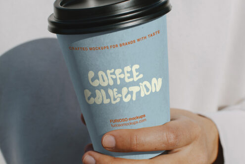 Sky blue to-go cup with black lid in hand, pale Coffee Collection lettering on side