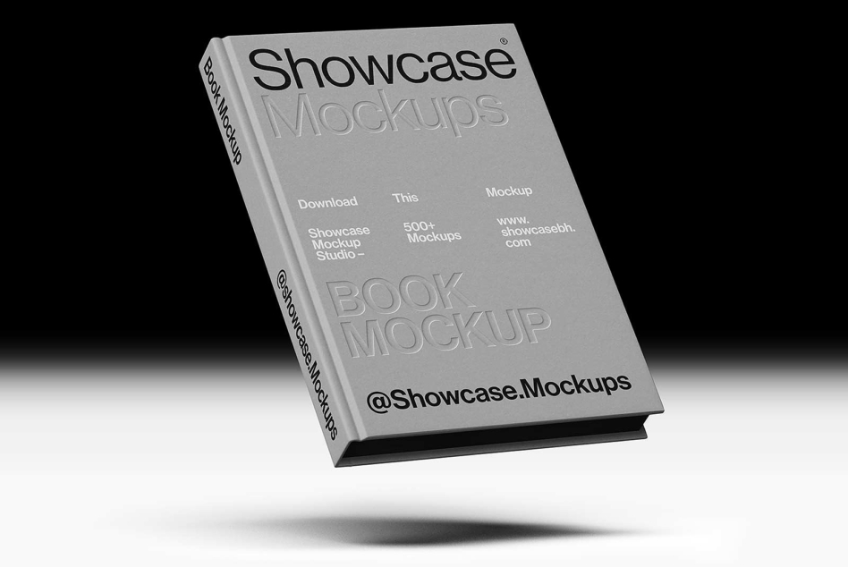 Gray hardcover book mockup tilted at angle showing front cover with Showcase Mockups branding