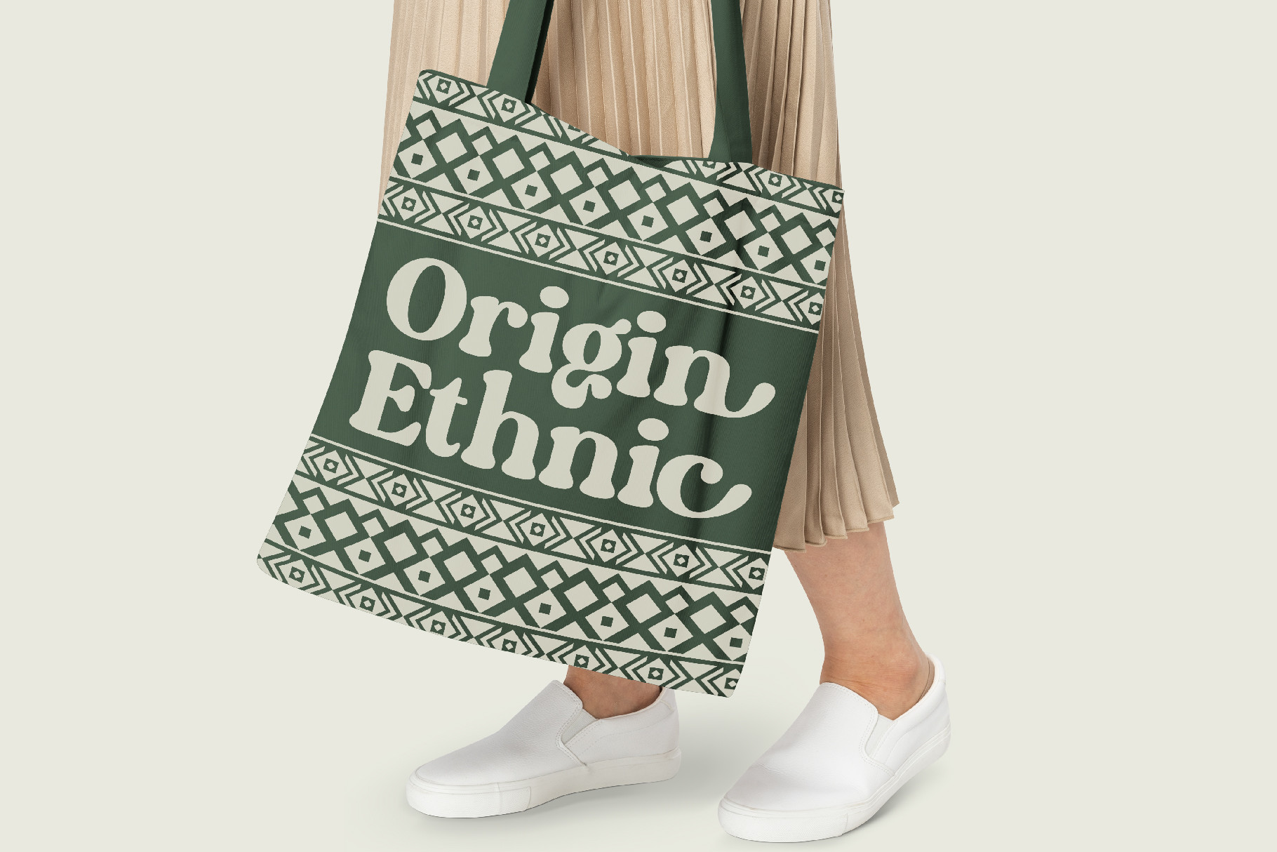 Green tote bag with Origin Ethnic geometric pattern mockup on model