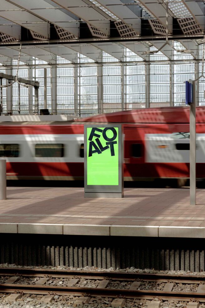Bright neon green billboard mockup on train platform with red white commuter train passing by