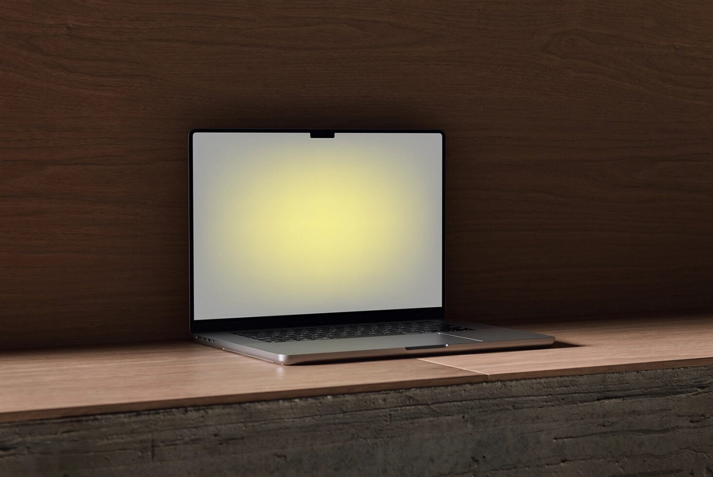 Laptop mockup sitting on wooden table with dark wood background, screen glowing