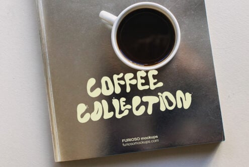 Close up of dark book cover showing white mug with black coffee inside