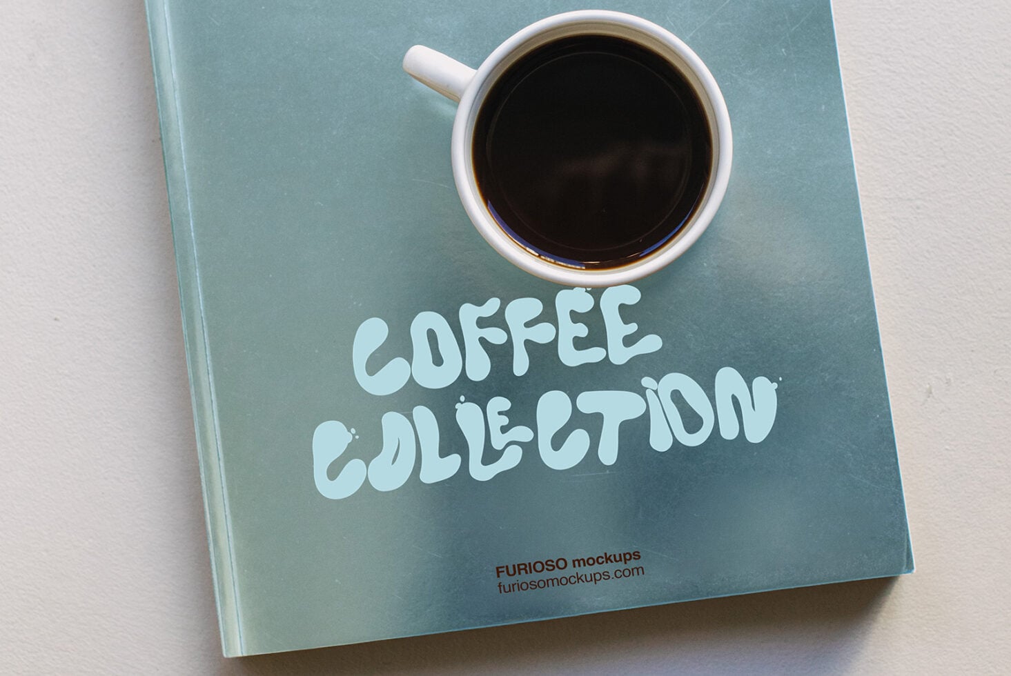White coffee cup with black coffee on blue journal with coffee collection text