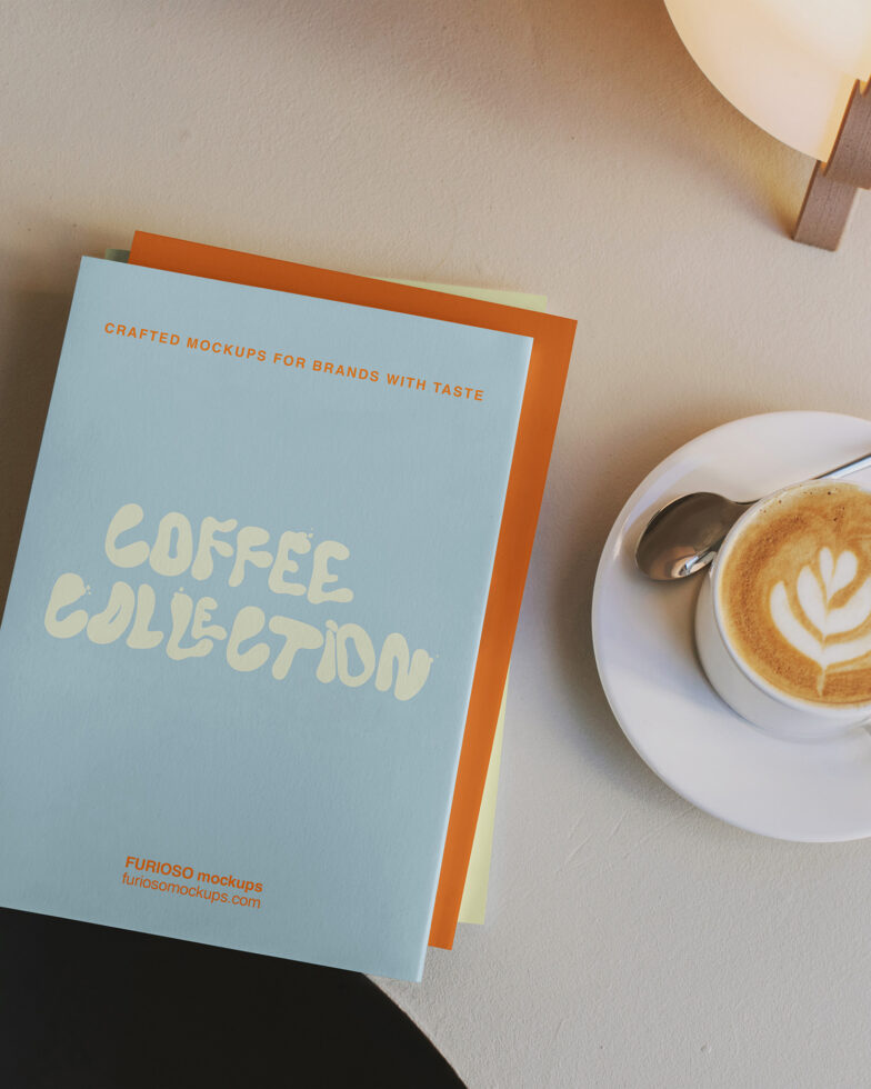Light blue cover with cream handwritten text, orange spine, coffee cup beside