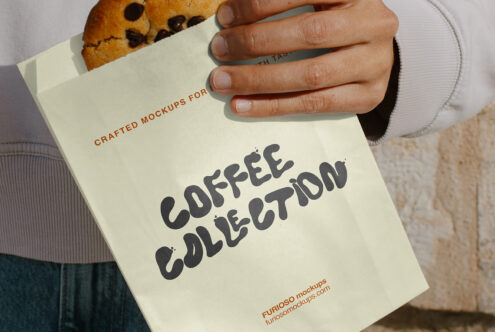 Cream paper bag with cookie sticking out, showing Coffee Collection design in bold lettering