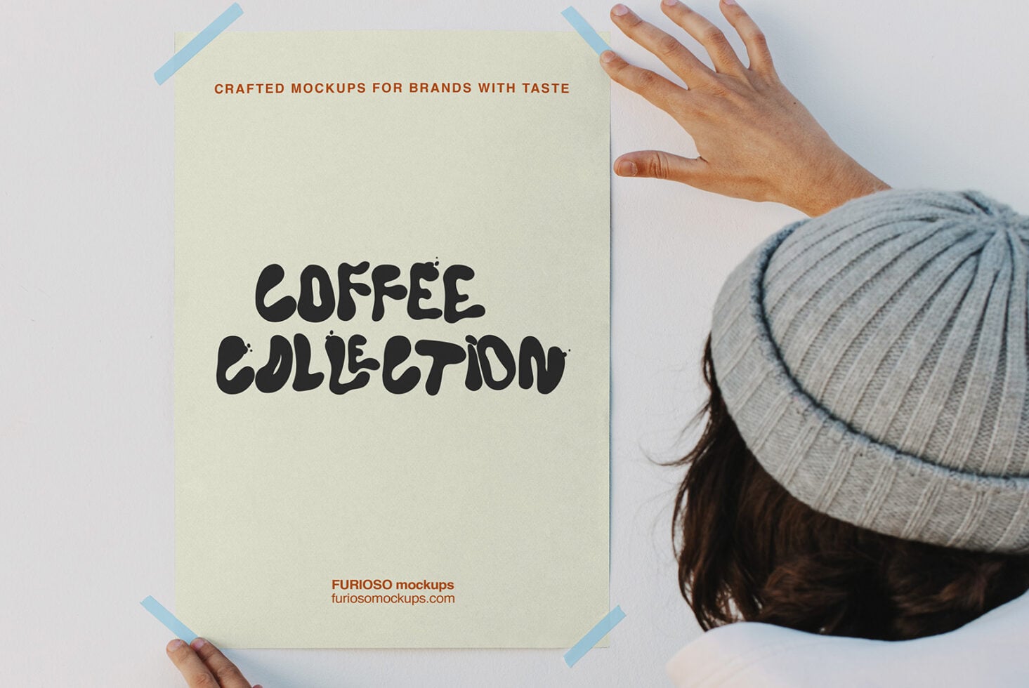 Person in beanie holding cream poster with Coffee Collection text, blue tape corners