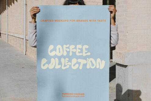 Person holding light blue poster with cream text saying Coffee Collection by brick wall