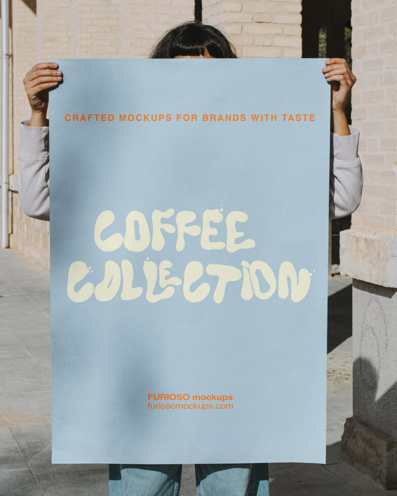 Person holding light blue poster with cream text saying Coffee Collection outdoors