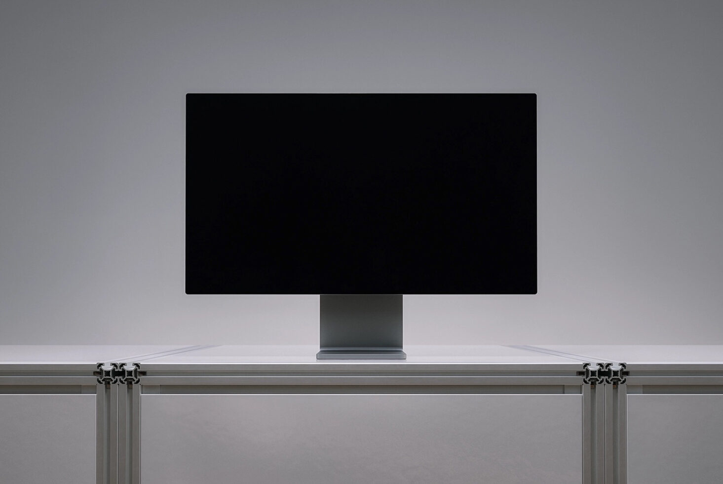 Desktop monitor mockup with black screen sitting on modern desk with curtain rod