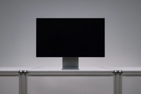 Desktop monitor mockup with black screen sitting on modern desk with curtain rod