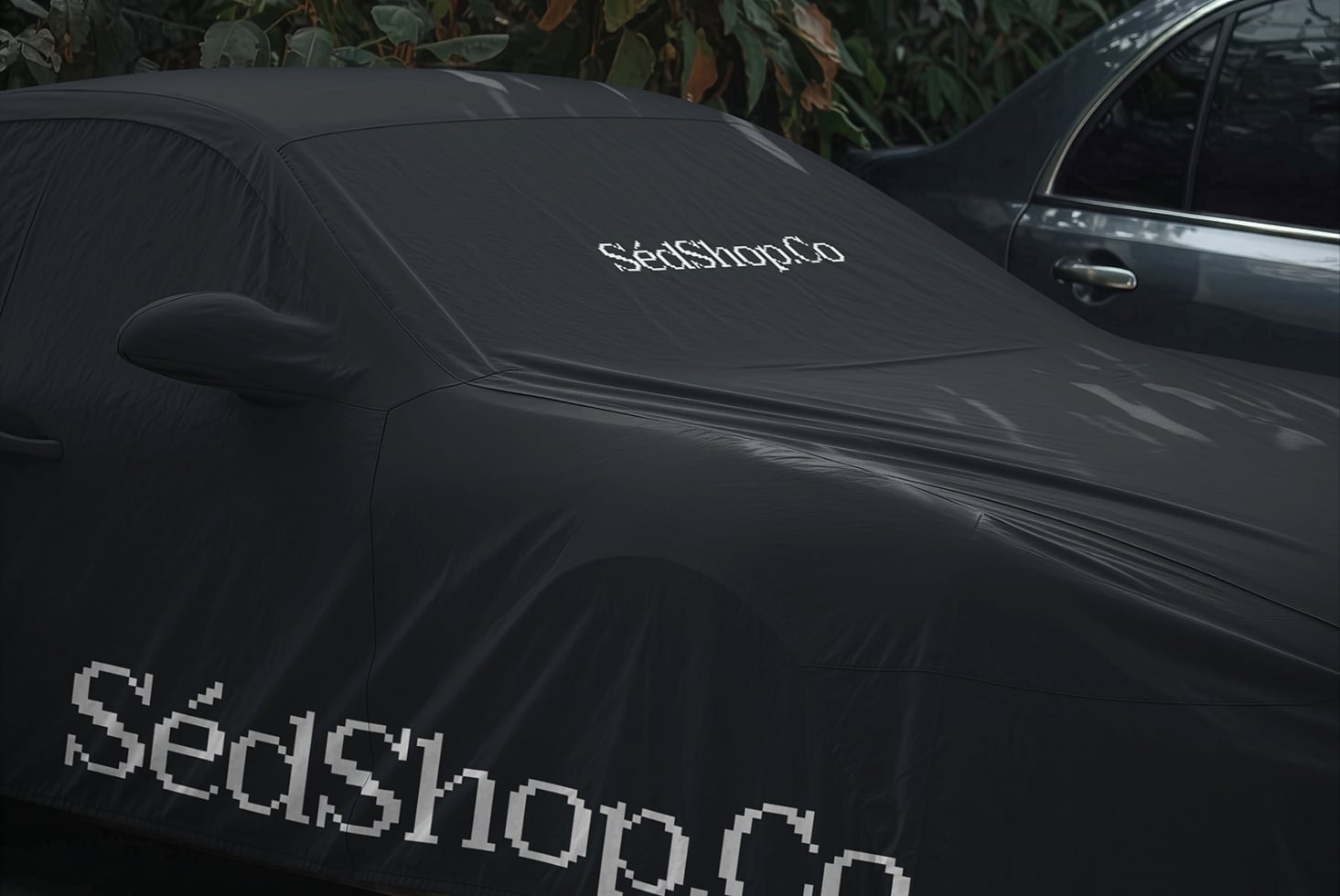 Black car windshield cover mockup with pixelated retro font logo displayed