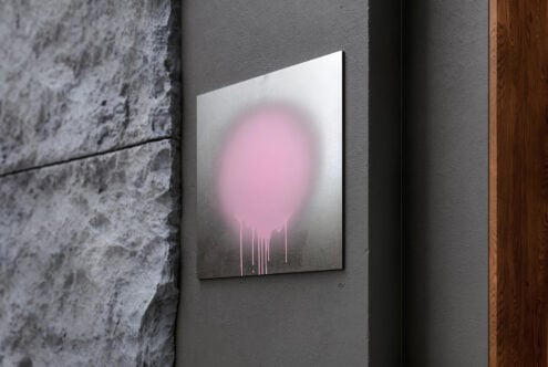 Canvas with soft pink glow effect mounted on industrial wall