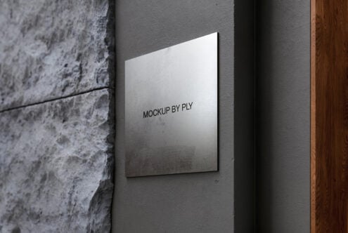 White canvas mounted on textured gray wall between concrete pillar