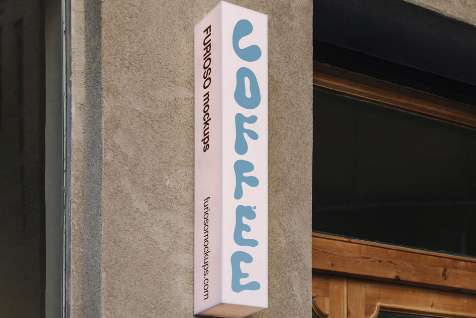 Vertical white box sign with blue rounded letters reading coffee displayed on concrete