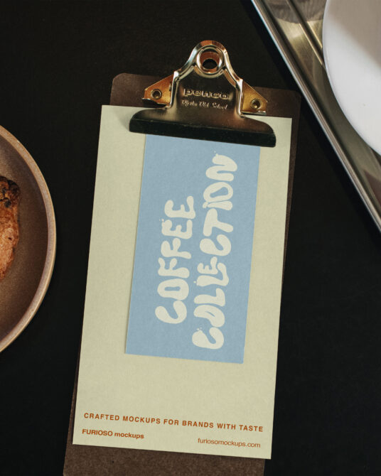 Clipboard mockup on dark surface with coffee cup latte nearby showing blue tag