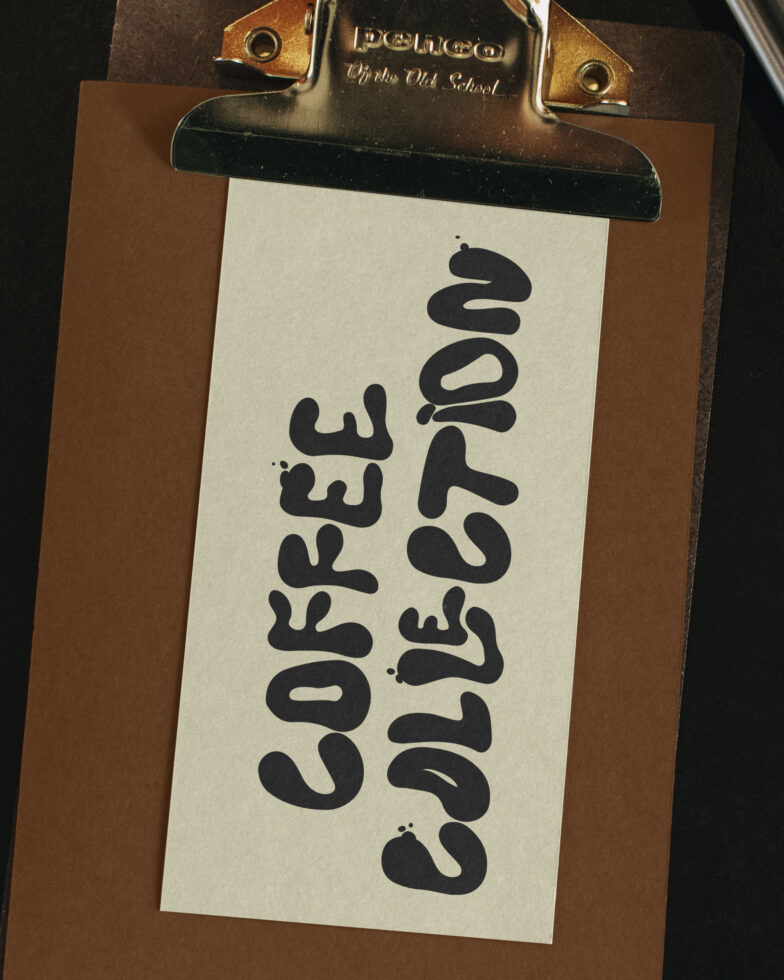 Vintage clipboard with brass clip holding white card with Coffee Collection text