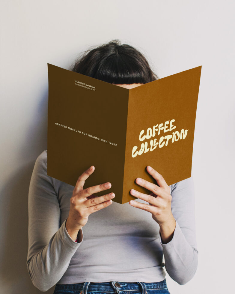 Person holding open gold hardcover book with Coffee Collection text on cover