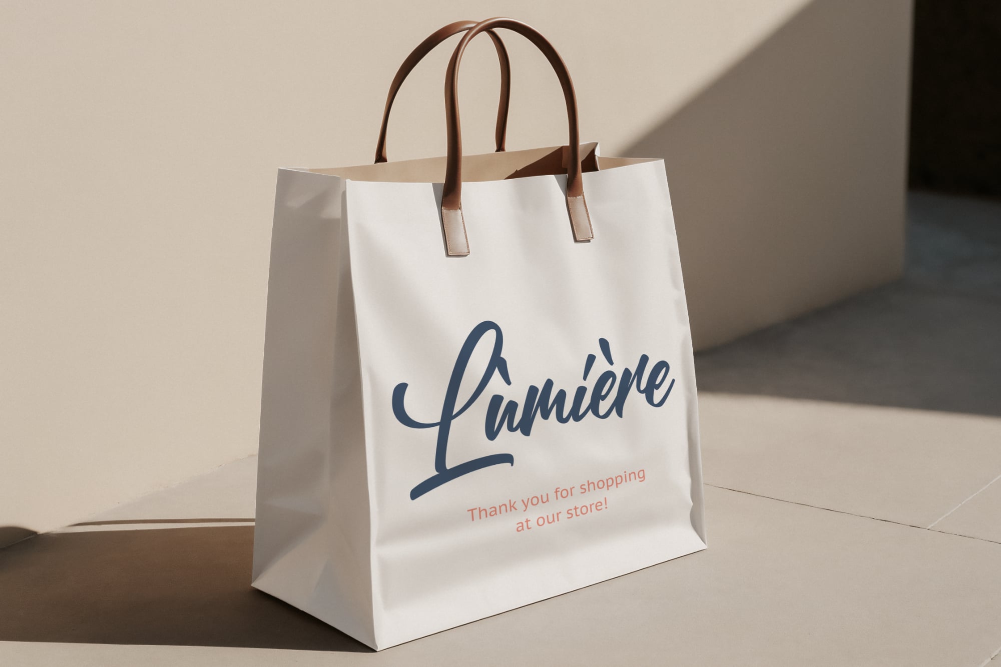 White shopping bag mockup with brown leather handles, Lumiere branding in navy script