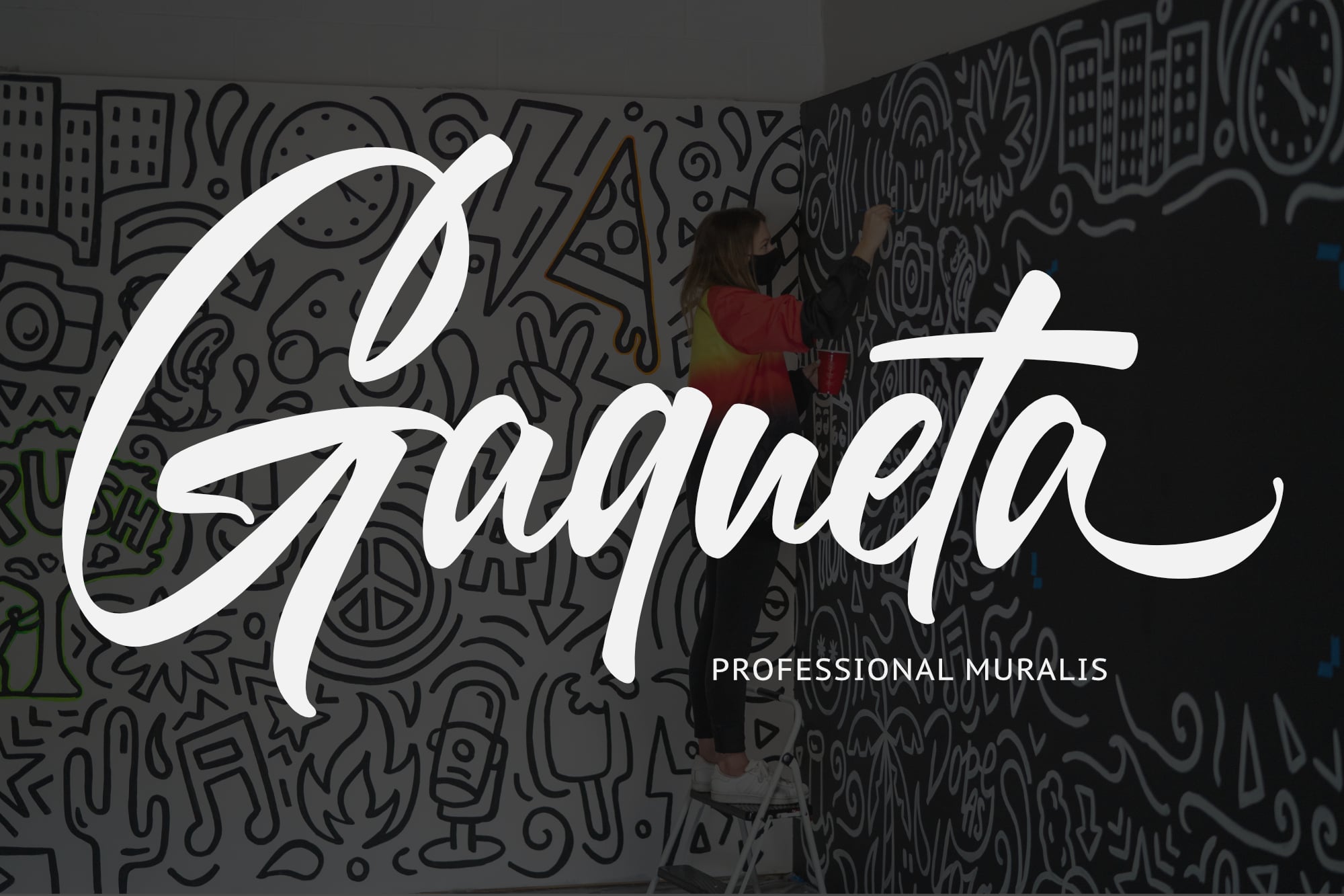 Flowing script typography overlaid on intricate doodle mural wall with person painting