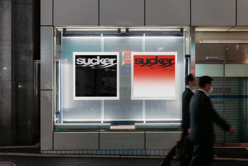 Store window display mockup showing two posters with black to red gradient on perforated metal backdrop