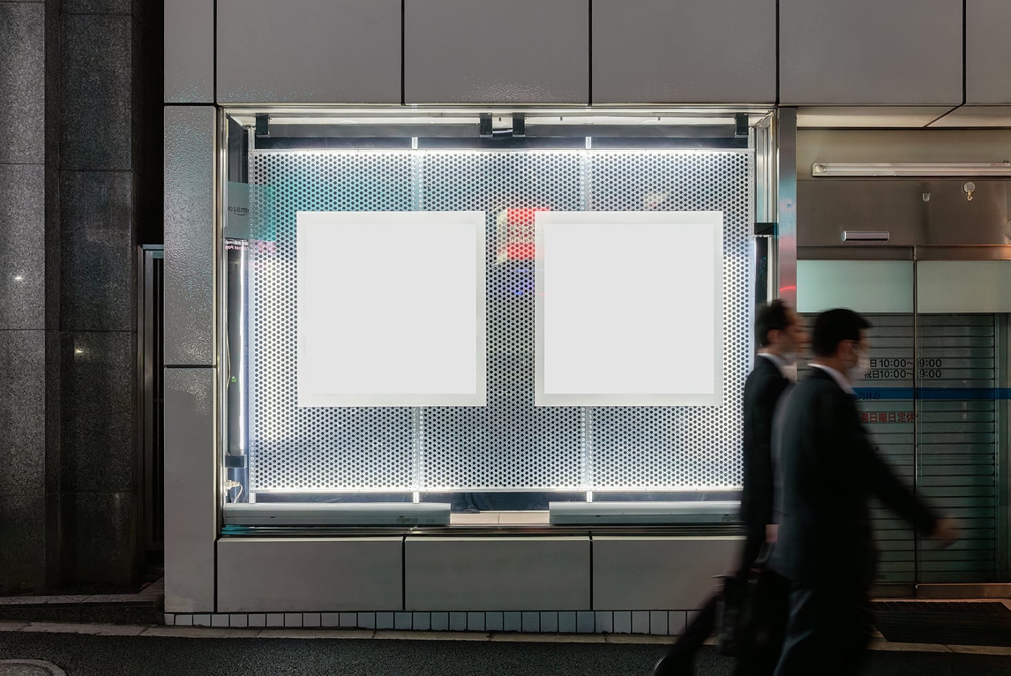 Storefront window mockup with two blank poster frames on perforated metal backdrop, urban street scene with blurred pedestrians passing by