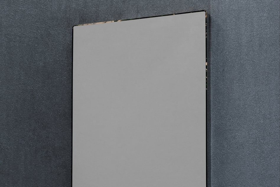 Blank poster mockup leaning against textured dark gray wall, ready for your design