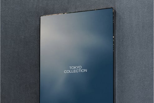 Dark blue book cover mockup with Tokyo Collection text on textured gray background