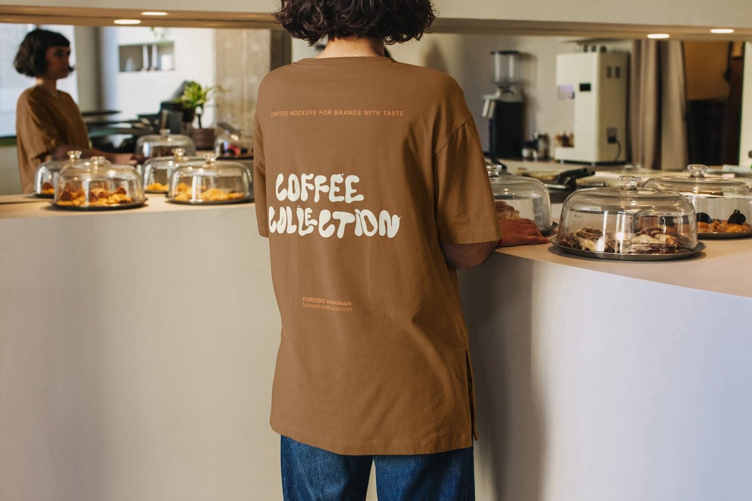 Brown crewneck shirt displaying coffee collection design indoors