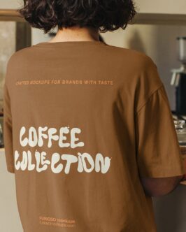 Brown oversized tee back view worn indoors with coffee collection text